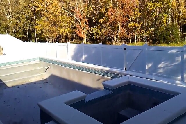 Empty pool with a vinyl pool fence